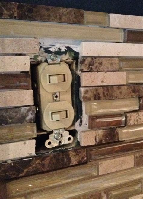 how to tile over an unused electrical box|tiling around electrical outlet.